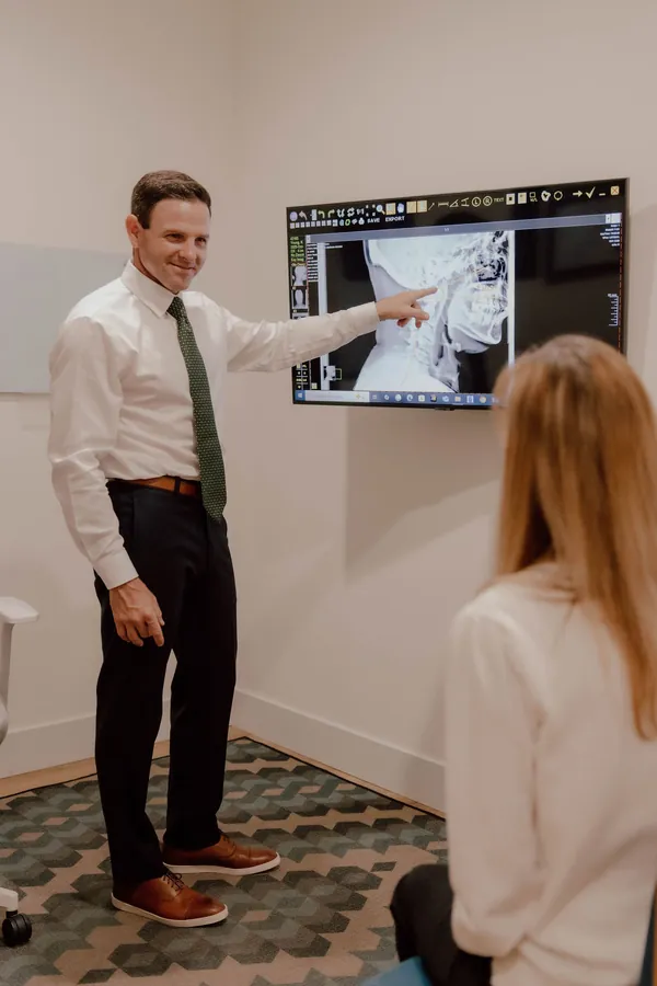 Dr. Collins walking a patient through their X-rays during a consultation